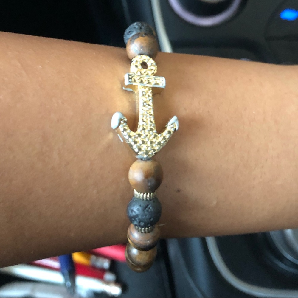 Wooden bead bracelet with gold colored anchor